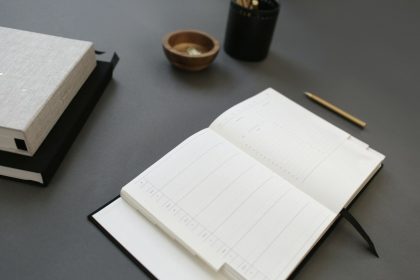 opened white notebook; self-employment ledger