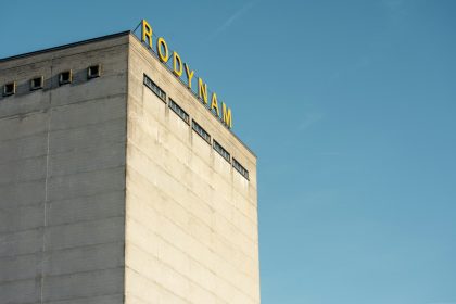 a tall building with a sign on top of it; corp to corp