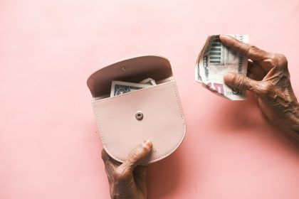 brown leather hand bag on pink table; how to pay yourself as a sole proprietor; how to pay yourself as a sole proprietor