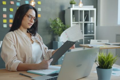 Woman working with documents at office desk; May CPI report