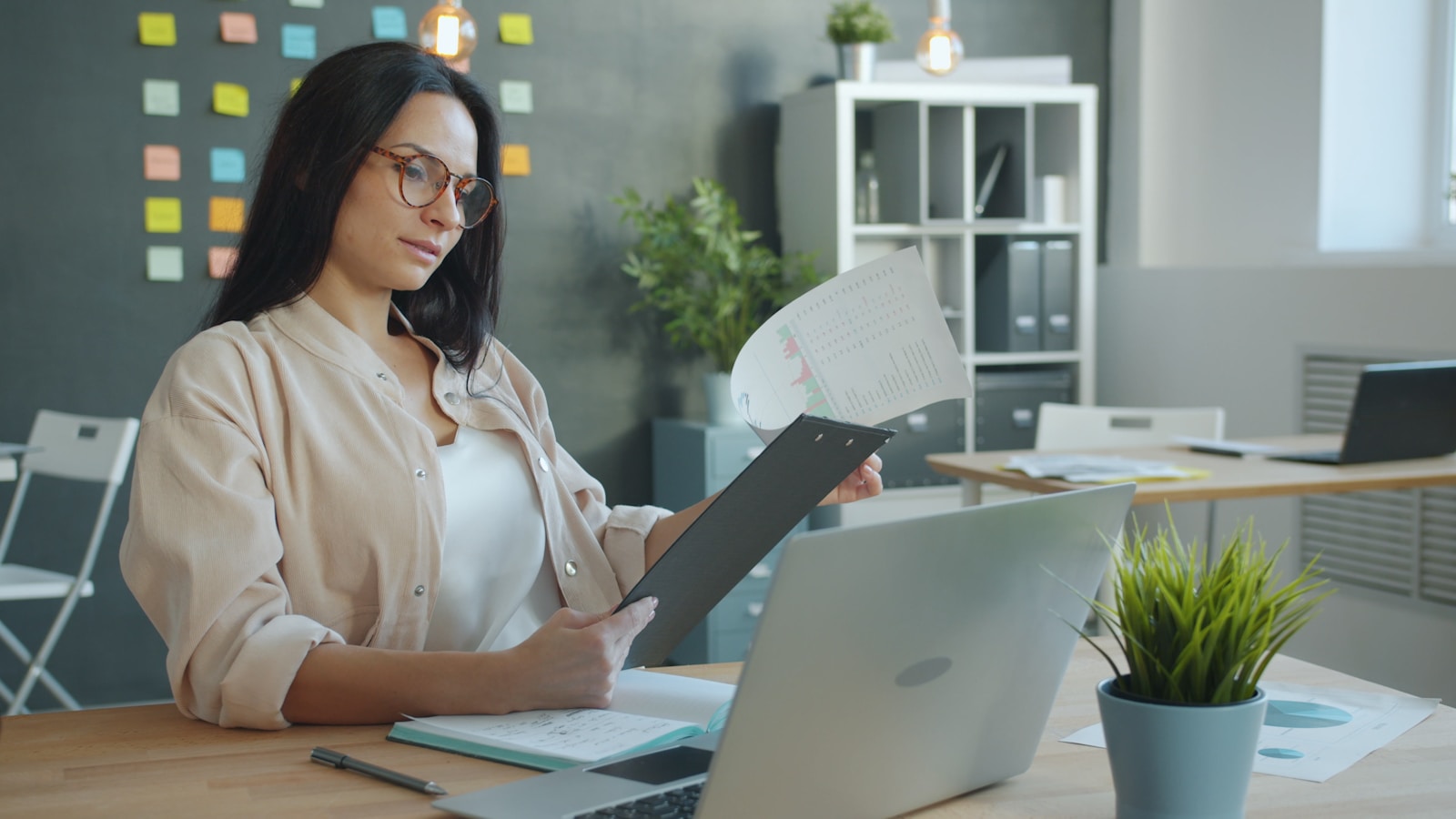 Woman working with documents at office desk; ADP National Employment Report May