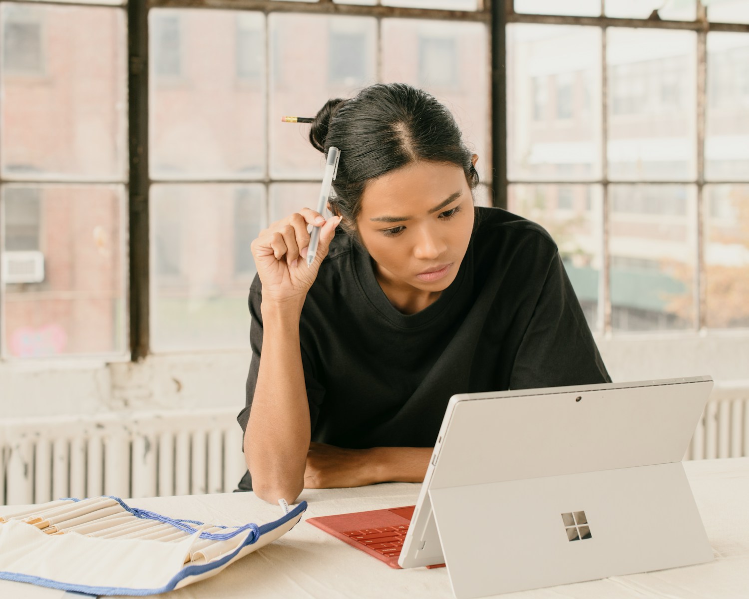 a woman sitting at a table using a laptop computer; May PPI report 2026