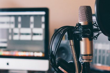black and silver headphones on black and silver microphone; video podcast