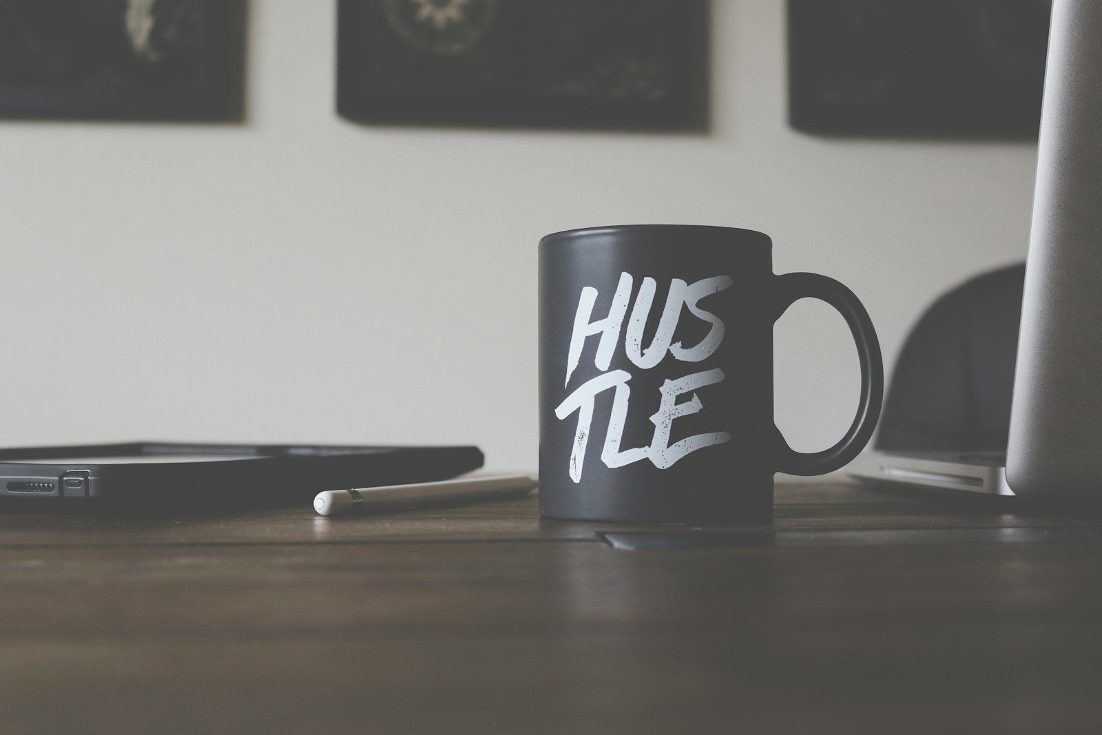 black and white Hustle-printed ceramic mug on table; Gen Z side hustles