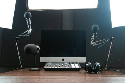 a computer on a desk; podcast equipment
