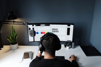man in black shirt sitting in front of computer; tech freelancers