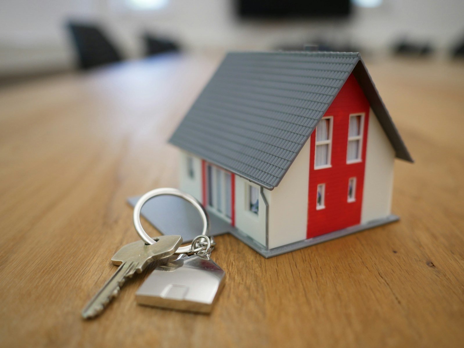 white and red wooden house miniature on brown table; new home sales June 2026