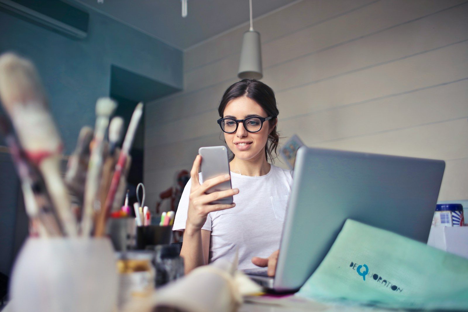 woman in white shirt using smartphone; creator middle class