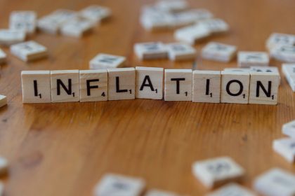 Inflation is spelled out using scrabble tiles.; July CPI report