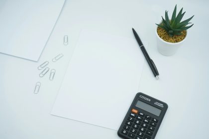 black calculator beside black pen on white printer paper; SBA loan citizenship rule