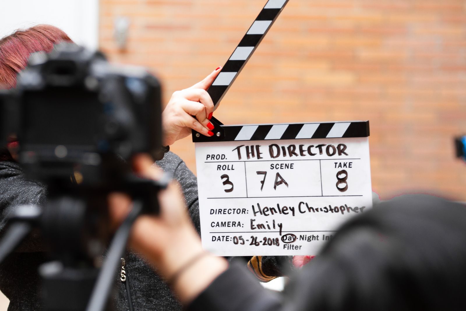 Close-up of film clapperboard in action with camera filming a take on set; federal film production incentive