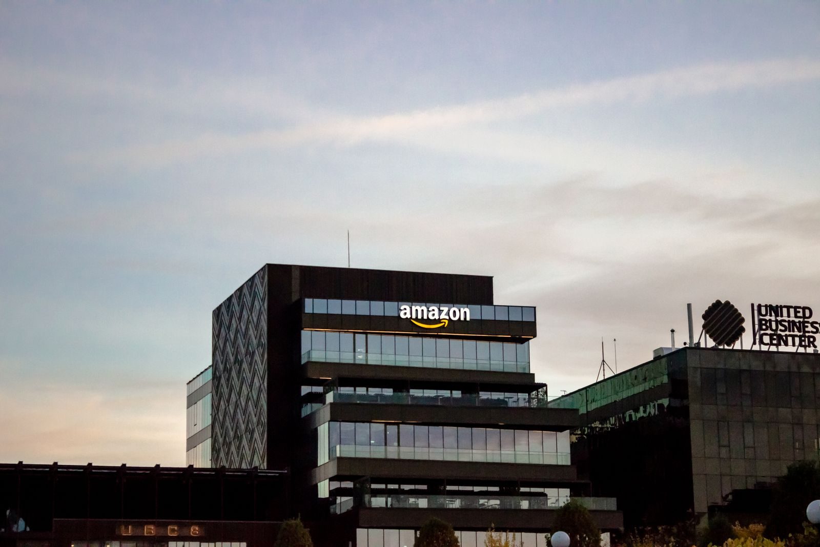 Contemporary architecture showcasing Amazon office at dusk in Iași, Romani; Amazon Seller Central multichannel