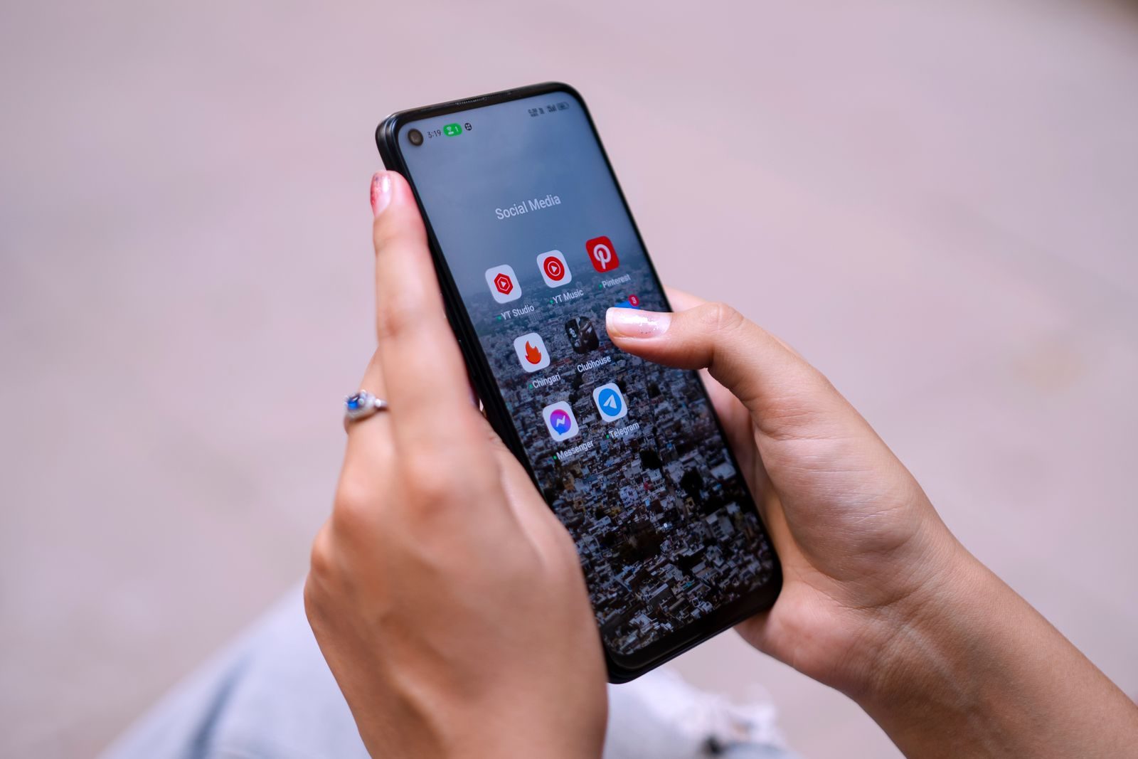 Close-up of hands holding a smartphone displaying social media apps, emphasizing digital connectivity; Gemini connected apps