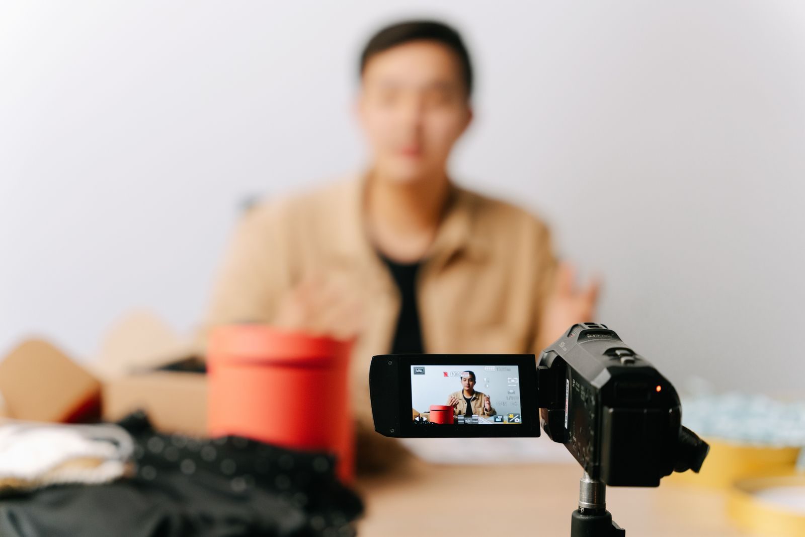 A blogger sits in front of a camera for filming a video indoors; Unilever creator marketing