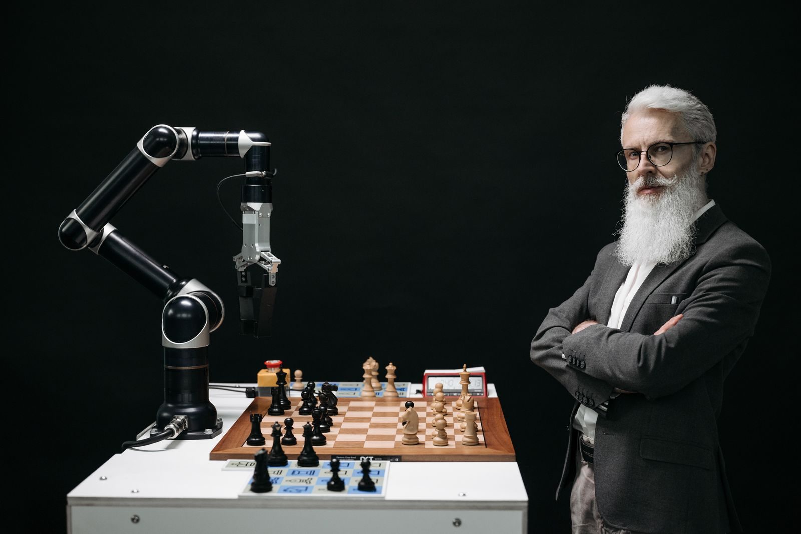 A robotic arm and a bearded man engaged in a strategic chess game highlighting technology and innovation; solopreneurs AI