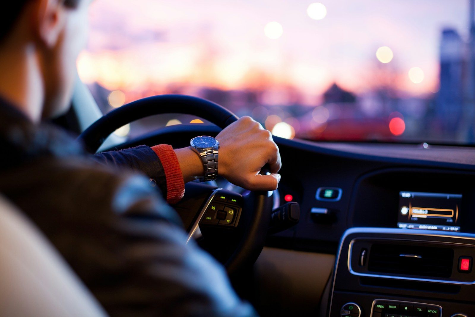 man driving a car wearing wrist watch; IRS mileage rate 2026
