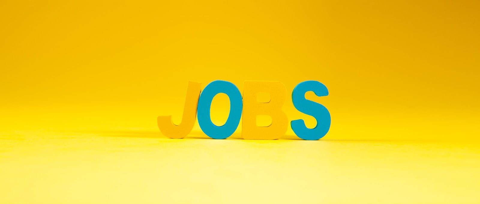 The word jobs in large letters on yellow; BLS benchmark revision