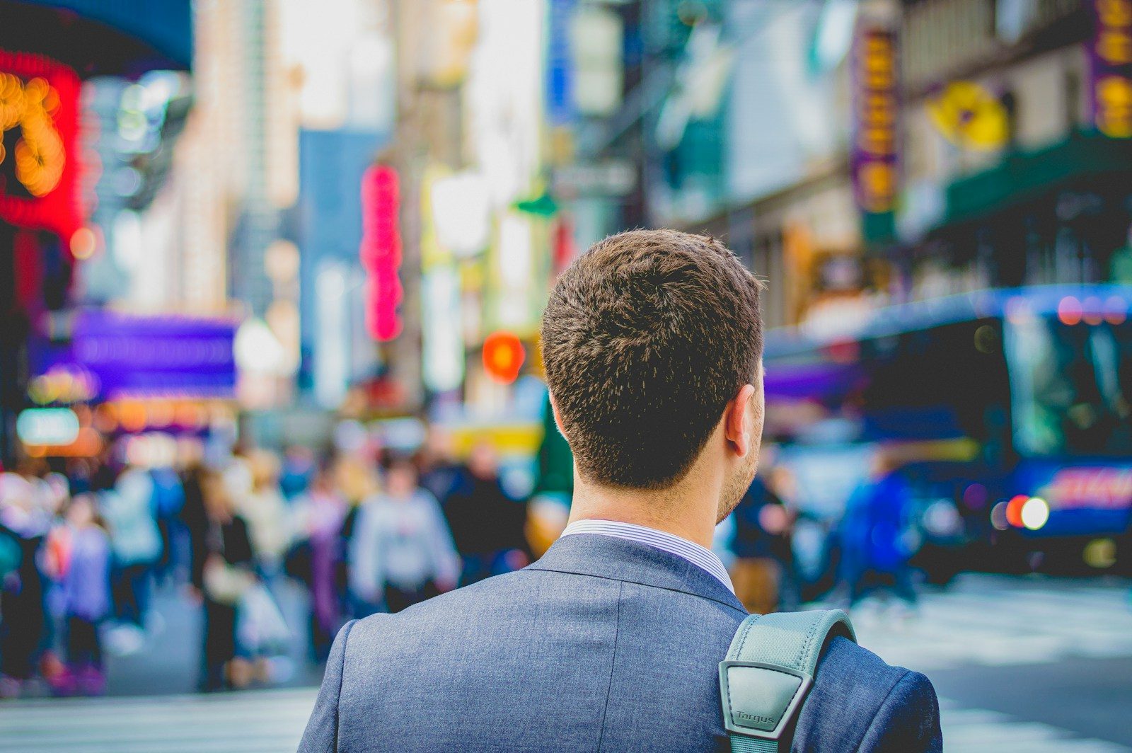 shallow focus photography of man in suit jacket's back; job openings July 2026