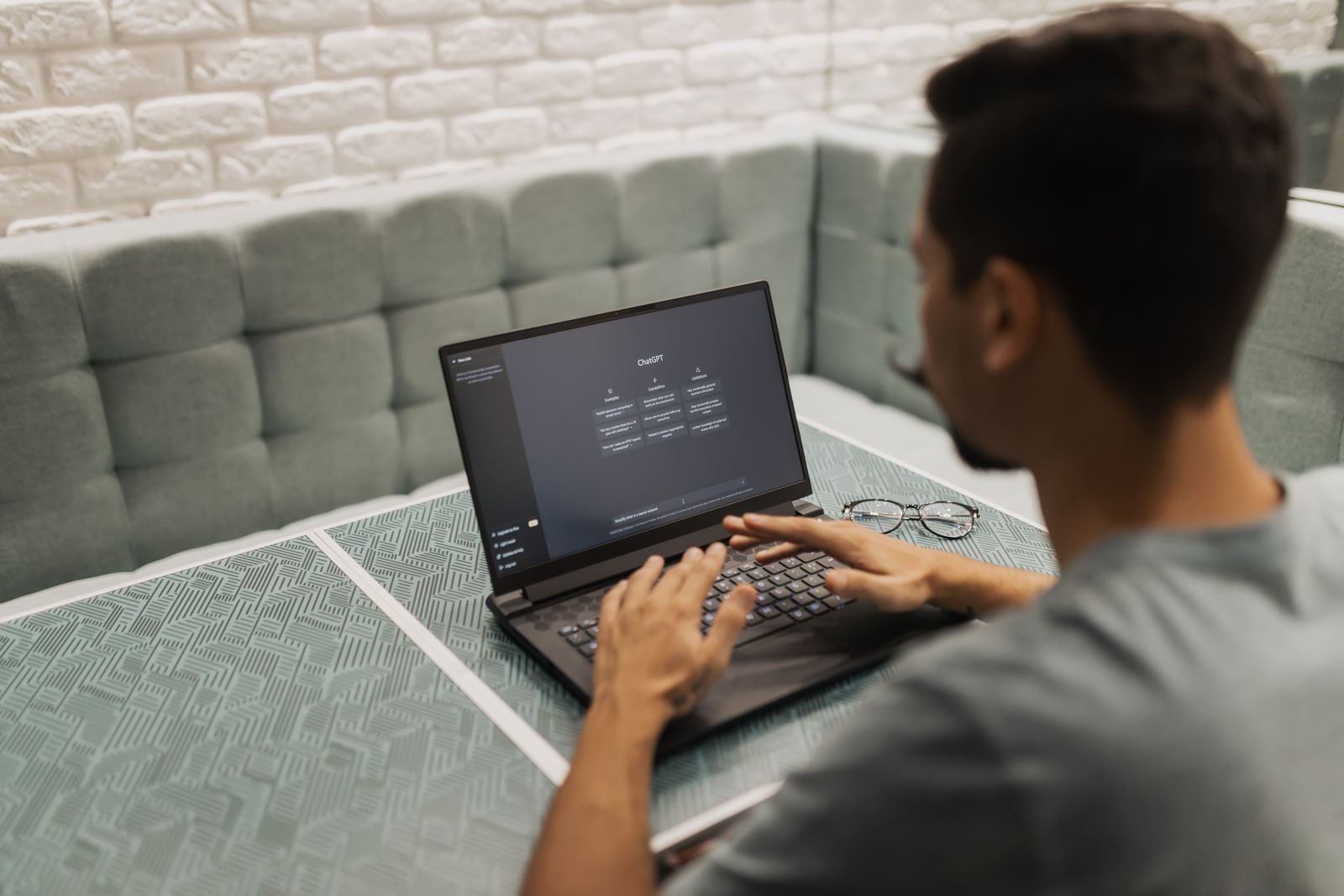 A man working on a laptop in a cozy, modern office space with a focus on technology; AI workforce platform