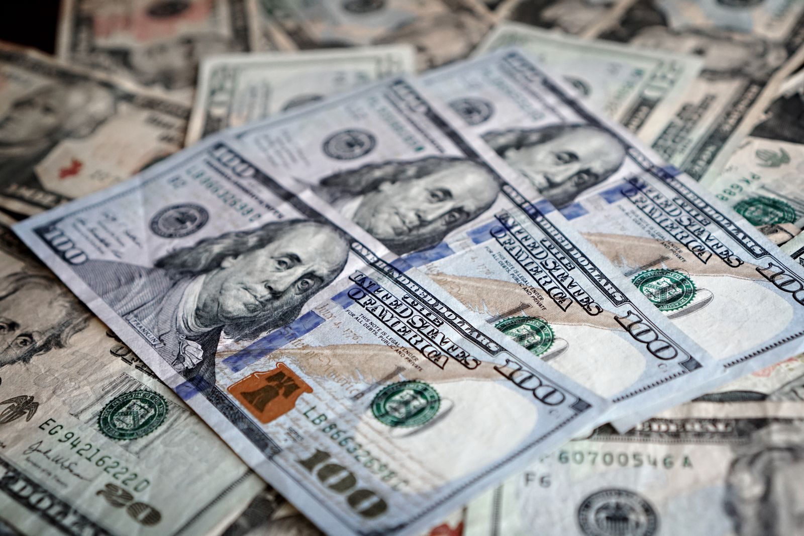 Close-up of various US dollar bills highlighting finance and economy; 2027 Social Security wage base