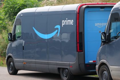 Blue electric delivery vans parked outdoors, highlighting modern urban logistics; Prime Big Deal Days